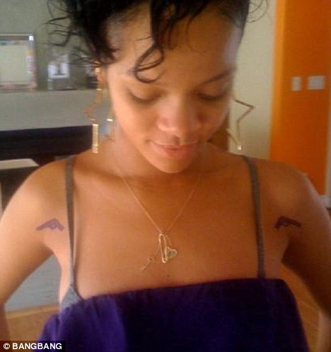 rihanna tattoos on hand. Rihanna Gets Gun Tattoo
